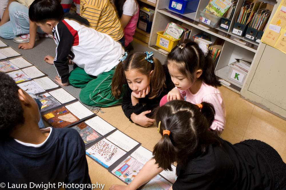 Grade 2 students collaborating on language arts sequencing activity Elementary school students working on language arts sequencing activity
