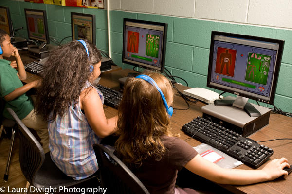 First grade students using computers in science class