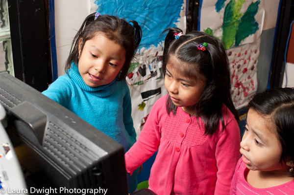 Game-based learning: 5 year old girls playing game on computer 5 year old girls using computer to play educational game