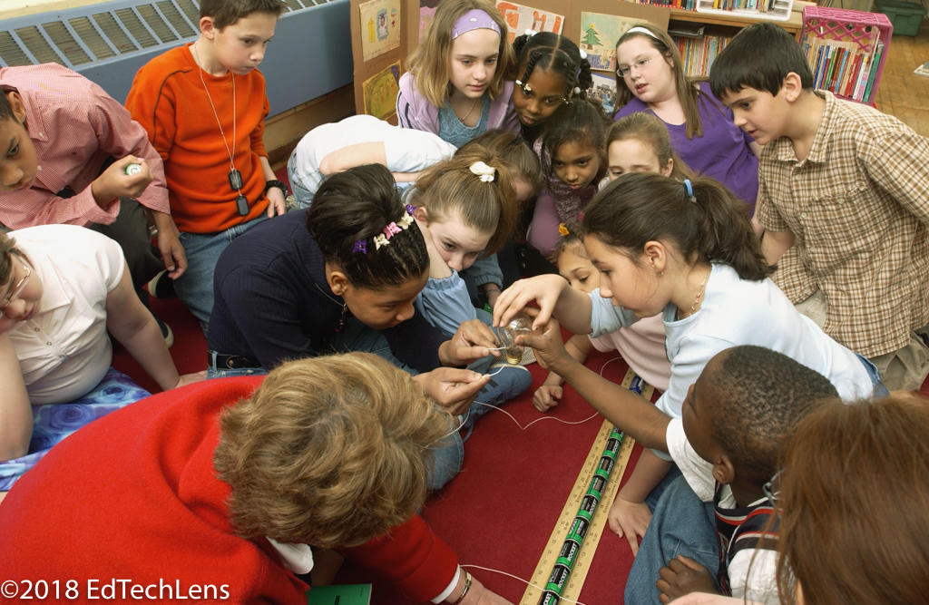 Fourth graders and their teacher explore electrical currents together.