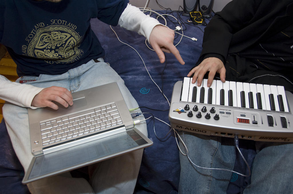 Teacher shows student how to use digital audio program with a keyboard 