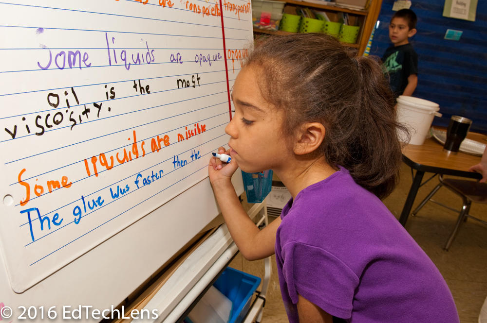 First-grade student uses science vocabulary (opaque, viscosity, and missable) as she writes her conclusion statement after an in-class science experiment.