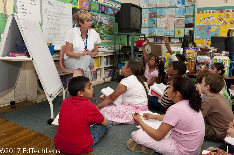 Third-grade teacher asks students questions after a session working on a problem-based learning activity exploring soil erosion and how it might be minimized or prevented. Third-grade teacher asks students questions after a session working on a problem-based learning activity exploring soil erosion and how it might be minimized or prevented.