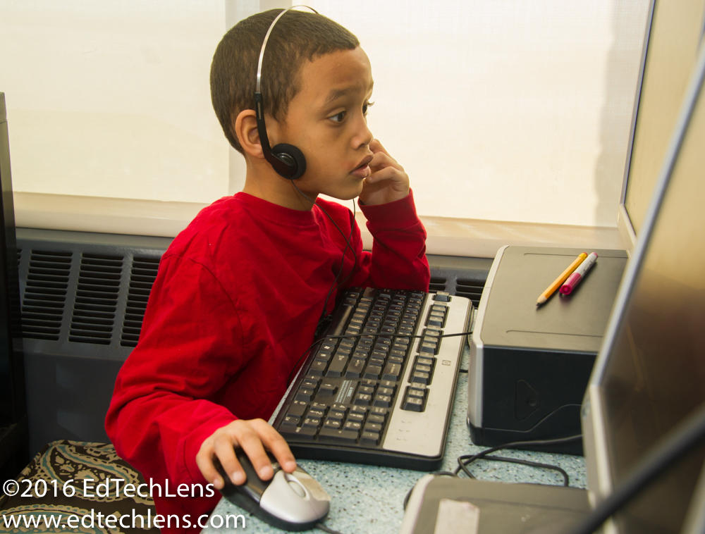 Kindergarten student uses computer during learning center time.