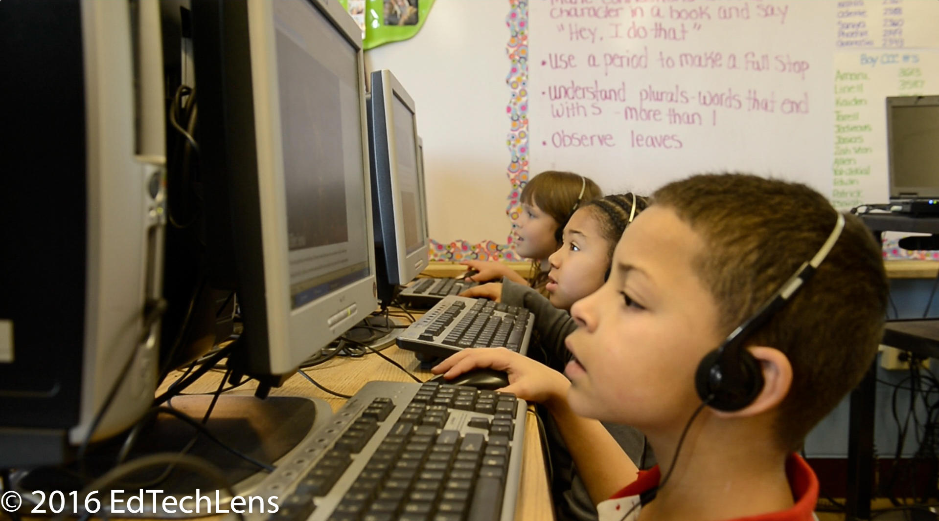 First-grade students use computers to proceed through multimedia lesson during learning center time. They are gathering the background they will need to complete more in-class work on the same concept.