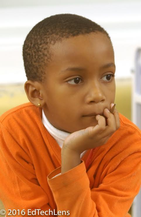 Second-grade boy listening and thinking in class.